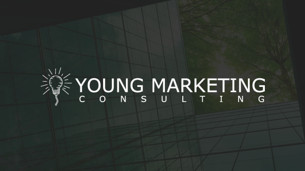 White YMC logo in center of black baground with transparency overlay of glass building with green trees and sun
