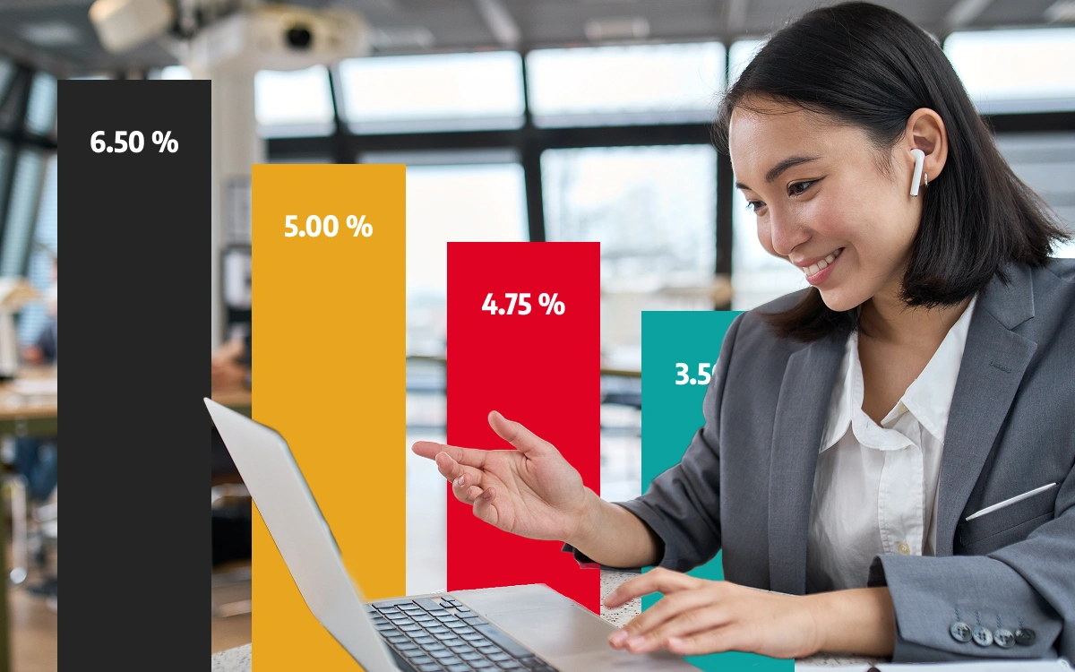 Woman sitting at laptop computer in business suit with bar chart overlay in background