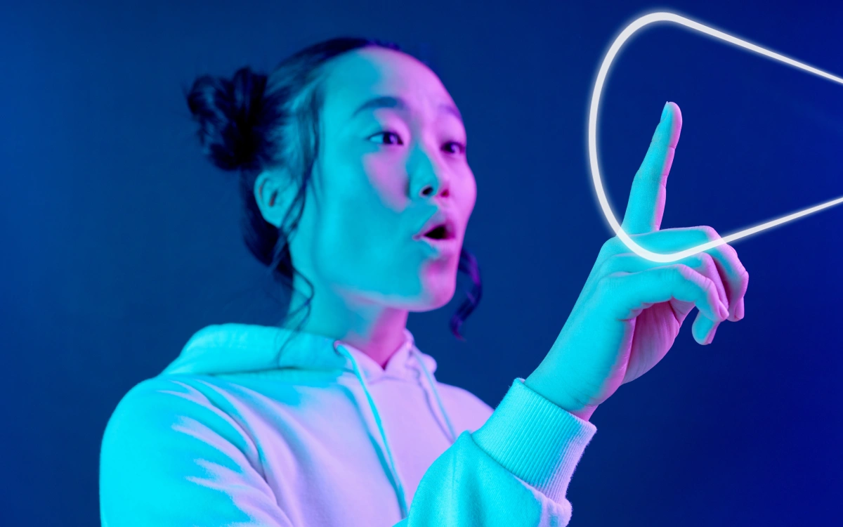 Young woman using pointer finger to click on search modal that is floating in the air in front of her