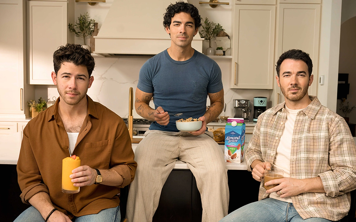 Jonas Brothers sitting in kitchen eating breakfast - Almond Breeze AI slop Ad